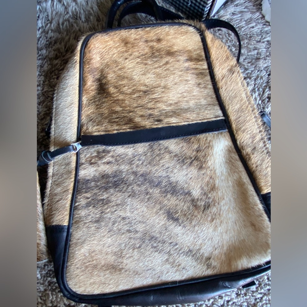 Cowhide backpack with matching wallet.